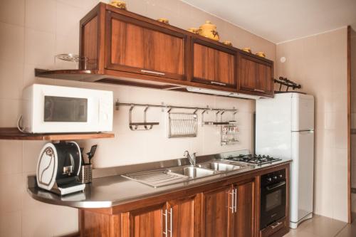 a kitchen with a sink and a microwave at Pompei Suite in Pompei