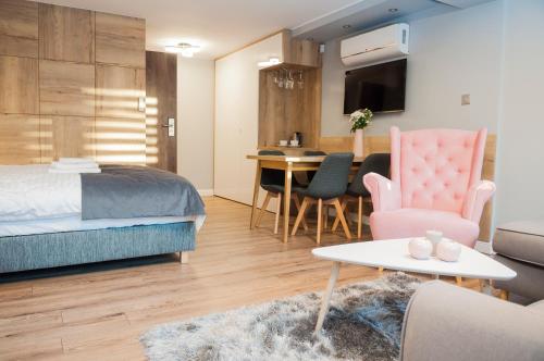 a bedroom with a bed and a living room at BALTIC PLAŻA przy plaży in Krynica Morska