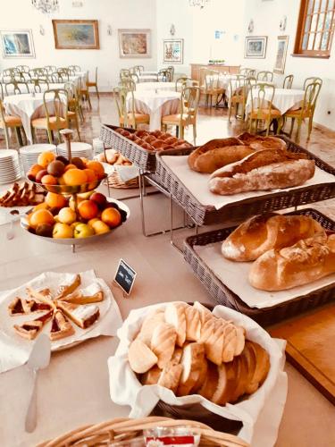 a table filled with different types of bread and pastries at Hotel Royal in Stresa
