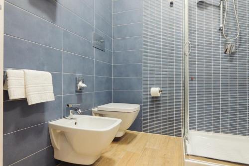 a bathroom with a toilet and a sink and a shower at Le Vele di Balestrate in Balestrate