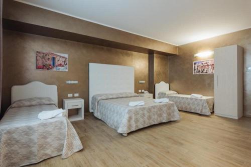 a hotel room with two beds in a room at Le Vele di Balestrate in Balestrate