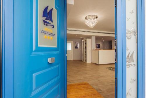a blue door in a room with a hallway at Le Vele di Balestrate in Balestrate