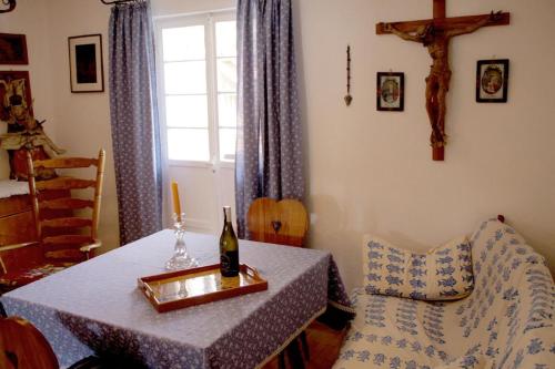 a table with a bottle of wine and a chair at Haus Poxleitner in Mauth