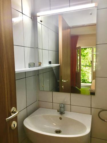a bathroom with a sink and a mirror at Vila Ana Trident Costinesti in Costinesti
