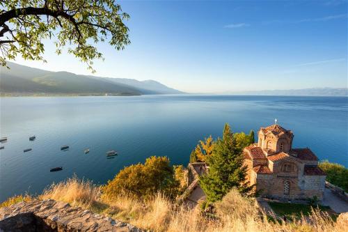 an old church on the shore of a lake at Bajam Apartments in Ohrid