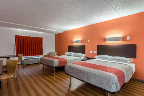 a hotel room with two beds and a table and chairs at Motel 6-White, GA - Cartersville in White