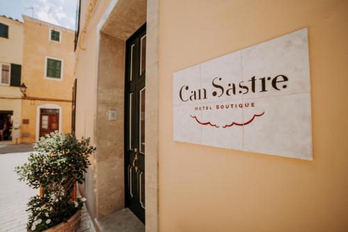 a sign on a building that reads can siesta with torture at Hotel Boutique Can Sastre in Ciutadella