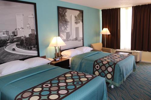 a hotel room with two beds and a large window at Super 8 by Wyndham Duncan in Duncan