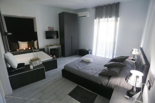 a bedroom with a large bed and a bath tub at ESPOSITO PLAZA- ROOMS & SUITE in Naples