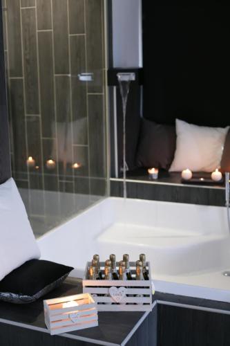 a bath tub with a box of bottles on a table at ESPOSITO PLAZA- ROOMS & SUITE in Naples