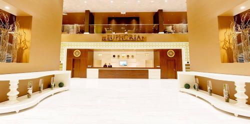 a large lobby with a counter in a store at Euphoria Batumi Convention & Casino Hotel in Batumi