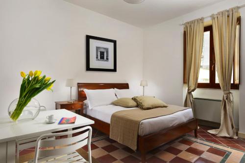 a bedroom with a bed and a table and a desk at Roma Resort Termini in Rome