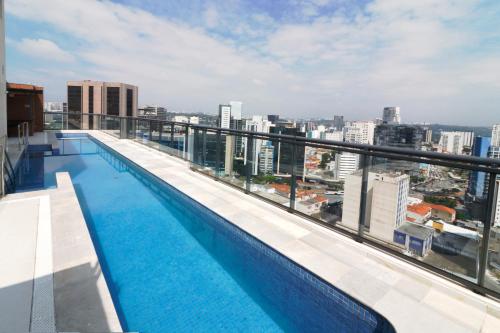 a swimming pool on the roof of a building at Hotel Residences Studio Pinheiros in Sao Paulo