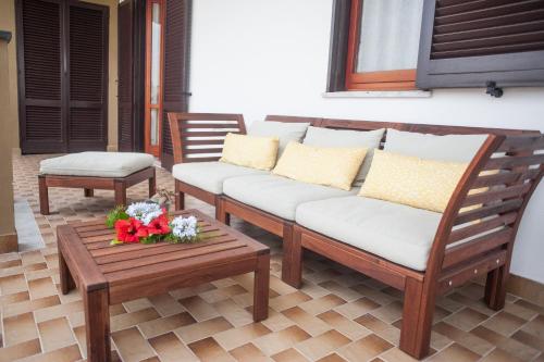 two chairs and a couch on a patio at Pompei Suite in Pompei