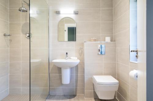 a bathroom with a sink and a toilet and a shower at Kathleens Country House in Killarney