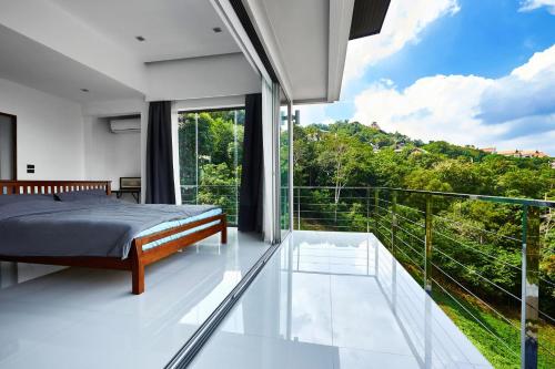 a bedroom with a bed on a balcony at villa Siam View Samui in Ban Bang Po