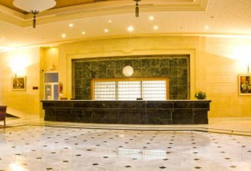 a large room with a fireplace and a stone floor at El Mouradi Djerba Menzel in Midoun