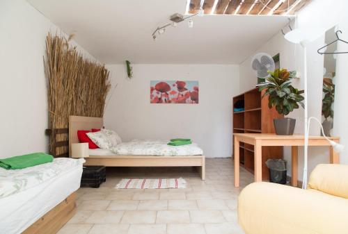 a living room with a couch and a table at Rastlinky.sk Greenhouse Guestrooms in Bratislava