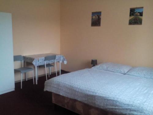 a bedroom with a bed and a table in it at U nových přátel in Lichkov