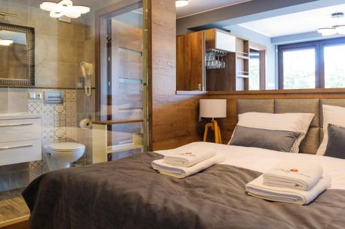 a bedroom with a bed with two towels on it at BALTIC PLAŻA przy plaży in Krynica Morska