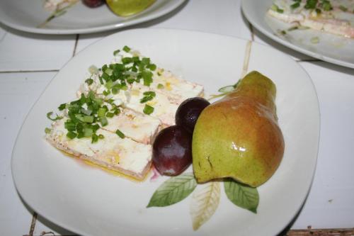 a plate of food with fruit and a pear at Auberge Keur Diame in Dakar