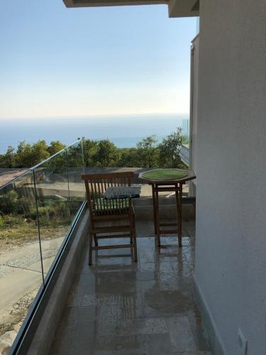a patio with a table and chairs on a balcony at Villa Horus in Sveti Stefan