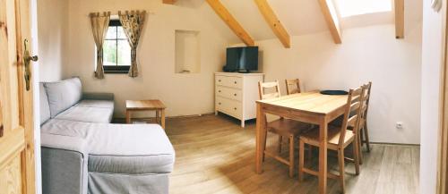 a living room with a table and a couch at Apartmány Sportrelax in Albrechtice v Jizerských horách