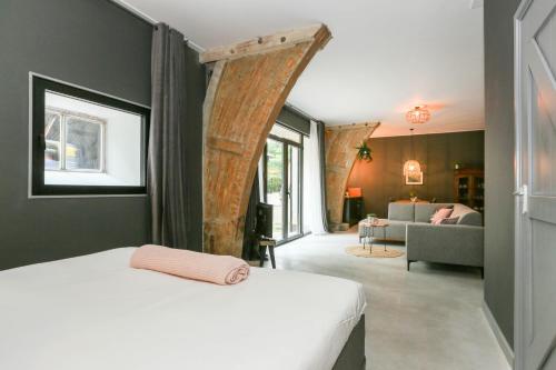 Un pat sau paturi într-o cameră la Adelaerthoeve Logies & Ontbijt