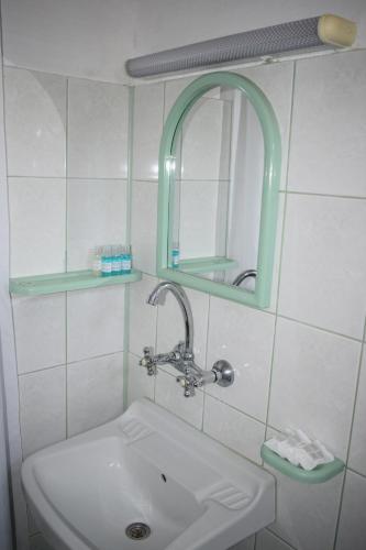 a bathroom with a sink and a mirror at Guest house Nedyalkovi in Chernomorets