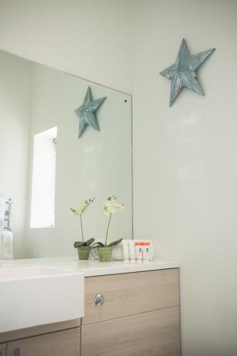 a bathroom with two blue stars above a mirror at George Hotel, BW Signature Collection in Norwich