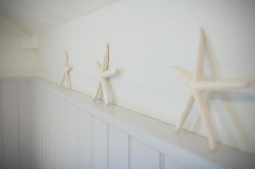 three wooden objects are on a white wall at George Hotel, BW Signature Collection in Norwich
