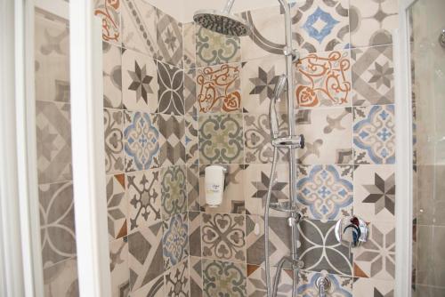 a shower in a bathroom with tiles on the wall at La Tenuta di Trimalcione in Pofi