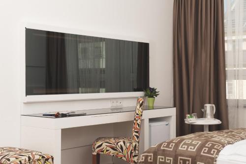 a hotel room with a large television on a wall at Hotel Bayer's in Munich