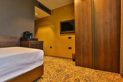 a hotel room with a bed and a tv at Hotel Zeta in Budva