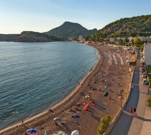a group of people on a beach with the water at Ethno House Ivanovic in Virpazar