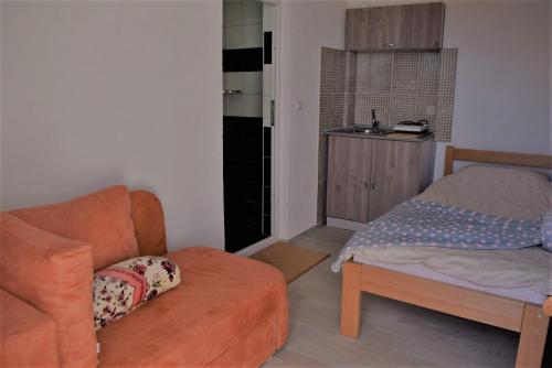 a living room with a couch and a chair at NULI apartments in Kruševo
