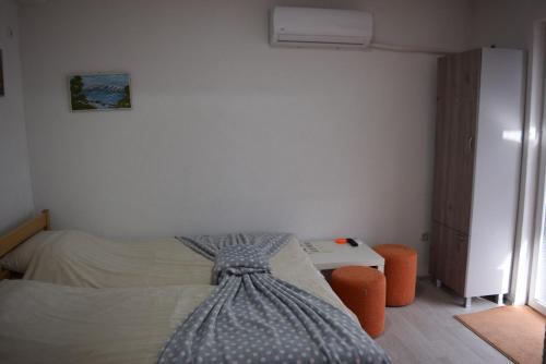 a bedroom with a bed with a dress on it at NULI apartments in Kruševo