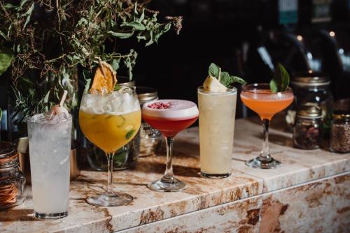 a group of different cocktails on a table at Lakes Hotel in Adelaide