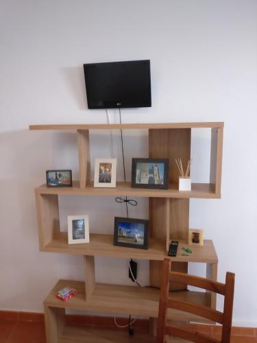 a shelf with a tv on a white wall at Casas do Megué in Évora