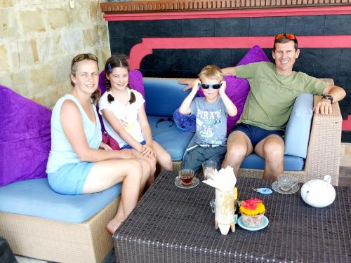a group of people sitting on a couch at Puri Oka Beach Bungalows in Candidasa
