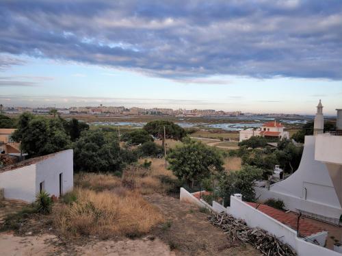 a view of a town with a river and a mosque at Sleep & Go Faro Airport Guest House in Faro