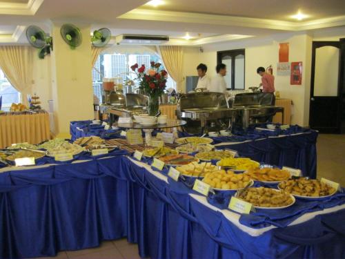 a table filled with different types of food on at Indochine Hotel in Kon Tum