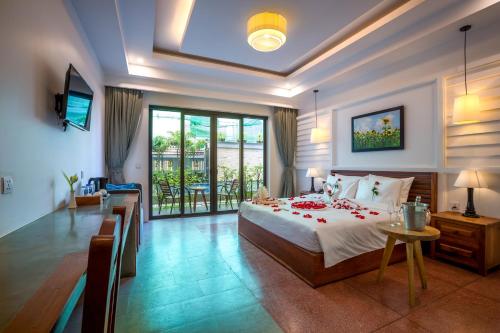 a bedroom with a large bed and a balcony at The Tito Suite Residence in Siem Reap