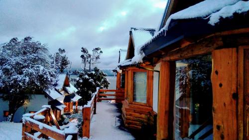 a log cabin with snow on the side of it at Don Justo in San Carlos de Bariloche