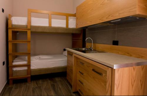a kitchen with a sink and a bunk bed at Hotel Pandora Residence in Tirana