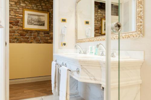 a bathroom with a sink and a mirror at Hotel Al Duca Di Venezia in Venice