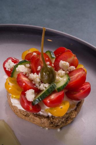 a piece of bread topped with vegetables on a plate at Lake Spirit Boutique Hotel & Spa in Ioannina