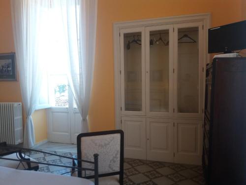 a room with a white cabinet and a window at Antico Palazzo Spinola in Gallipoli