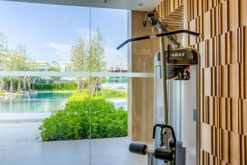 a glass door with a view of the water at LUX- VERANDA PATTAYA - Residence in Jomtien Beach