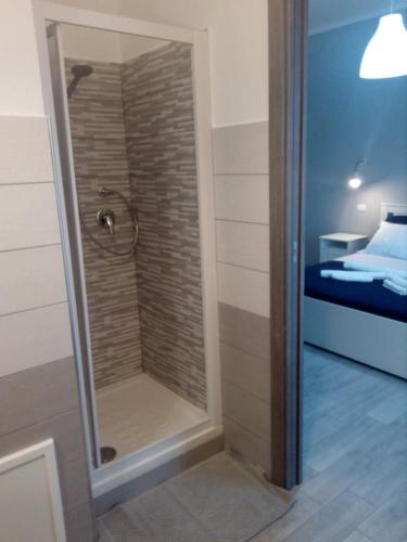a walk in shower in a room with a bedroom at Affitti Brevi Zu Tano e Za Carmela in Realmonte